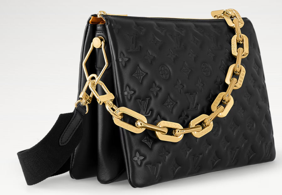 Angled view of the Coussin MM showing the gold chain and fabric shoulder strap